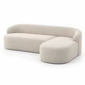 Divano componibile in tessuto beige con schienale curvo